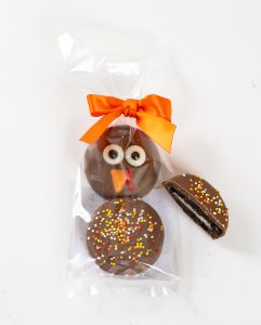 Hand decorated fall oreo cookies dipped in chocolate in a gift bag