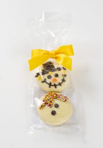Hand decorated fall oreo cookies dipped in chocolate in a gift bag