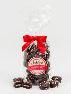 Chocolate covered oreos in a gift bag with crushed candy cane